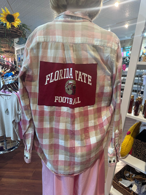 Plaid shirt with Florida State Football logo in a store setting