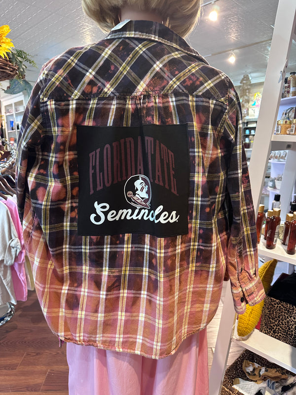 Plaid shirt with 'Florida State Seminoles' logo worn by a person in a store setting.